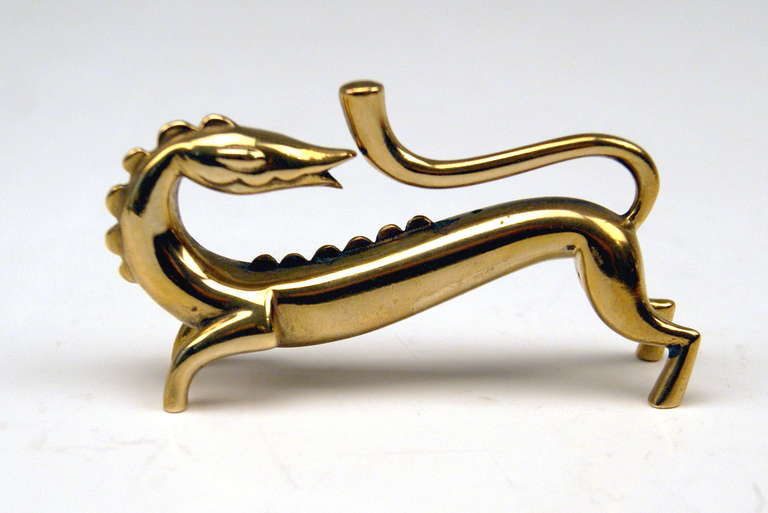 Very fine ART DECO DRAGON’S FIGURINE MADE OF BRASS  having smooth surface. The dragon is raising its tail  /  the animal figurine is turning itself backwards, too.   -  SIGNED at reverse side of figurine by VIENNESE HAGENAUER MANUFACTORY   ( = KARL