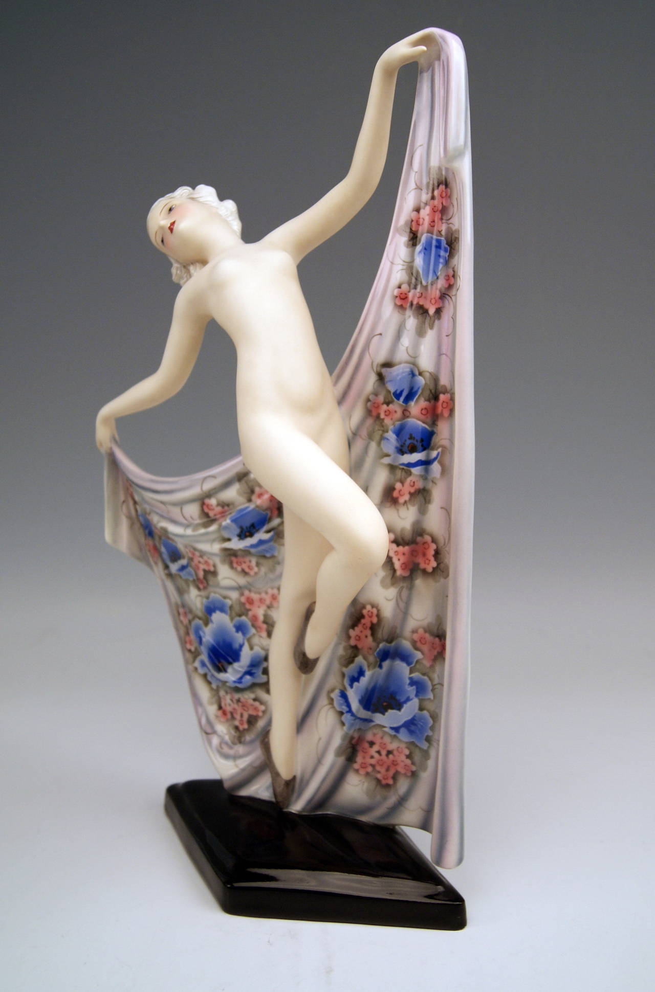 Most remarkable Goldscheider Figurine FEMALE DANCING NUDE
Model 8174
NUDE LADY DANCER SEIZING CORNERS OF DRAPERY COVERING FIGURINE'S BACK:  This model is called  'NOCTURNO' .

SIZE: 
height: 16.0 inches ( = 40.0 cm )
width:  12.0 inches ( =
