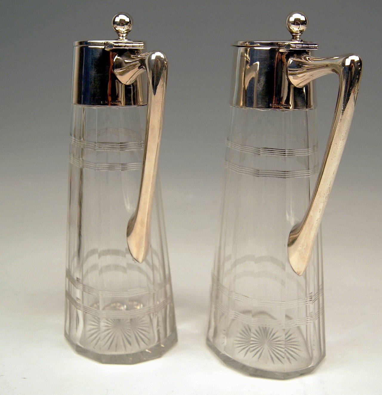 A Pair of Glass Decanters  (Carafes)  with Silver Mountings 
ART NOUVEAU  
MARK WTB: GERMANY / Schwaebisch Gmuend, manufactory Wilhelm Binder, number 8329         Letters  'VIETOR'  ( = probably master having produced these glass decanters