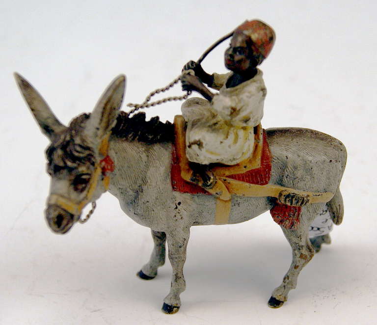 Gorgeous Vienna Bronze figurine made by famous manufactory Bergman(n)  circa 1890-1900. 
The Arab boy  - guiding a lovely donkey by reins   -  sits cross-legged on  saddle. The boy wears the characteristic Arab cap as well as long Arab dress.  - 