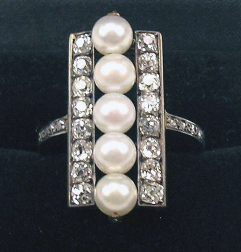 Golden Art Deco ring of high value with many diamonds (Vintage cuts  /  1.05 carat)  

Gold  ( checked / 14 ct    585)     /    Diamonds  (Vintage cuts  /  1.05  Carat)   &  five sea pearls

Most elegant ring:  
Best quality and high value (Finest