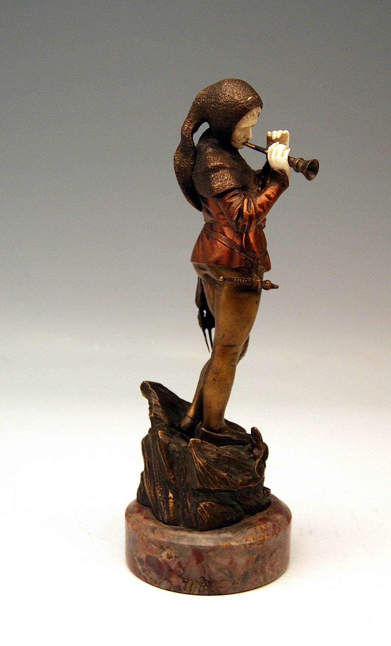 There is a  GORGEOUS BRONZE FIGURINE presented: 
It is The Pied Piper of Hamelin* playing the pipe.  
The figurine's impression is very fine - it is looking like very lifelike !  The man's figurine is clad in medieval garments  (hood, shirt,