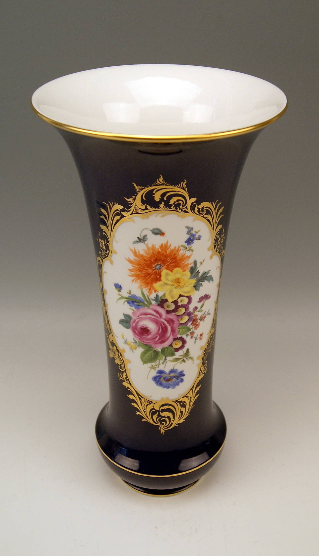 Gorgeous Tall Cobalt Blue Vase of Funneled Form Type.

MANUFACTORY:    MEISSEN

DATING:       made second half of 20th century   

MATERIAL:     
WHITE PORCELAIN, GLOSSY FINISH, FINEST FLOWER PAINTINGS

This stunning  MEISSEN VASE of