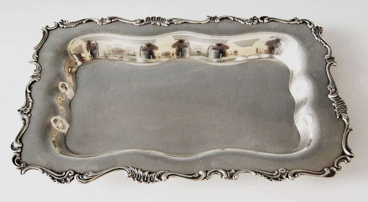 Italian silver excellent serving platter vintage
victorian period   /  made circa 1870

excellently made rectangular silver serving platter of finest quality.  the platter's middle area as well as part of edge have smooth surface  /  frame of