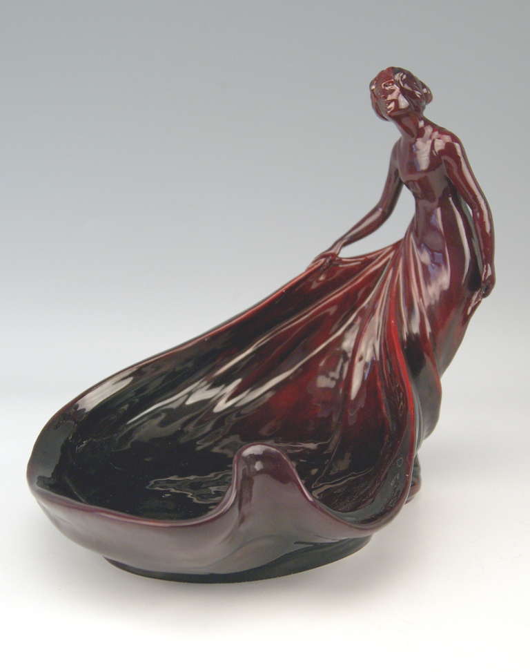 Zsolnay vintage quite large Art Nouveau nicest Eosin Bowl with a Sculptured Female Figurine.
Stunning ceramics bowl with gorgeous  eosin glaze shining purple, red, black.  The oblong or egg-shaped bowl has scalloped area, it is edge of a woman's 