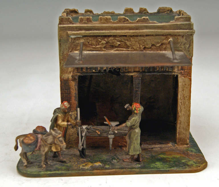 Gorgeous Vienna Bronze figurine group made by famous manufactory Bergman(n)  circa 1910. 
There is an  ARAB SMITH BEING BUSY AT ANVIL  visible   (the man works in front of his workshop of which doors have been opened)   /   the smith communicates