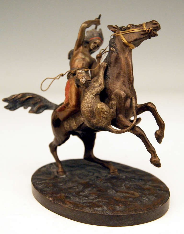 Gorgeous Vienna Bronze figurine created by famous bronze sculptor Carl Kauba (1865 - 1922). Made circa 1900. 

There is a riding red Indian seizing axe visible, being busy with fending off a cheetah or hunting leopard which had jumped on horse.