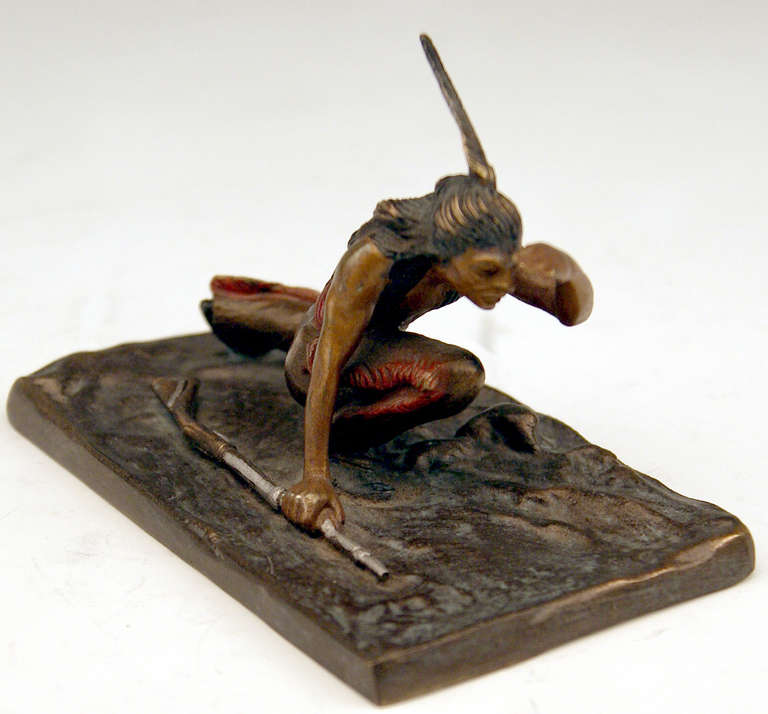 Gorgeous Vienna Bronze figurine created by famous bronze sculptor Carl Kauba (1865 - 1922).  Made circa 1910. 

There is a red Indian visible, being busy with stalking:  He is armed with rifle, looking around. The figurine is based on rectangular