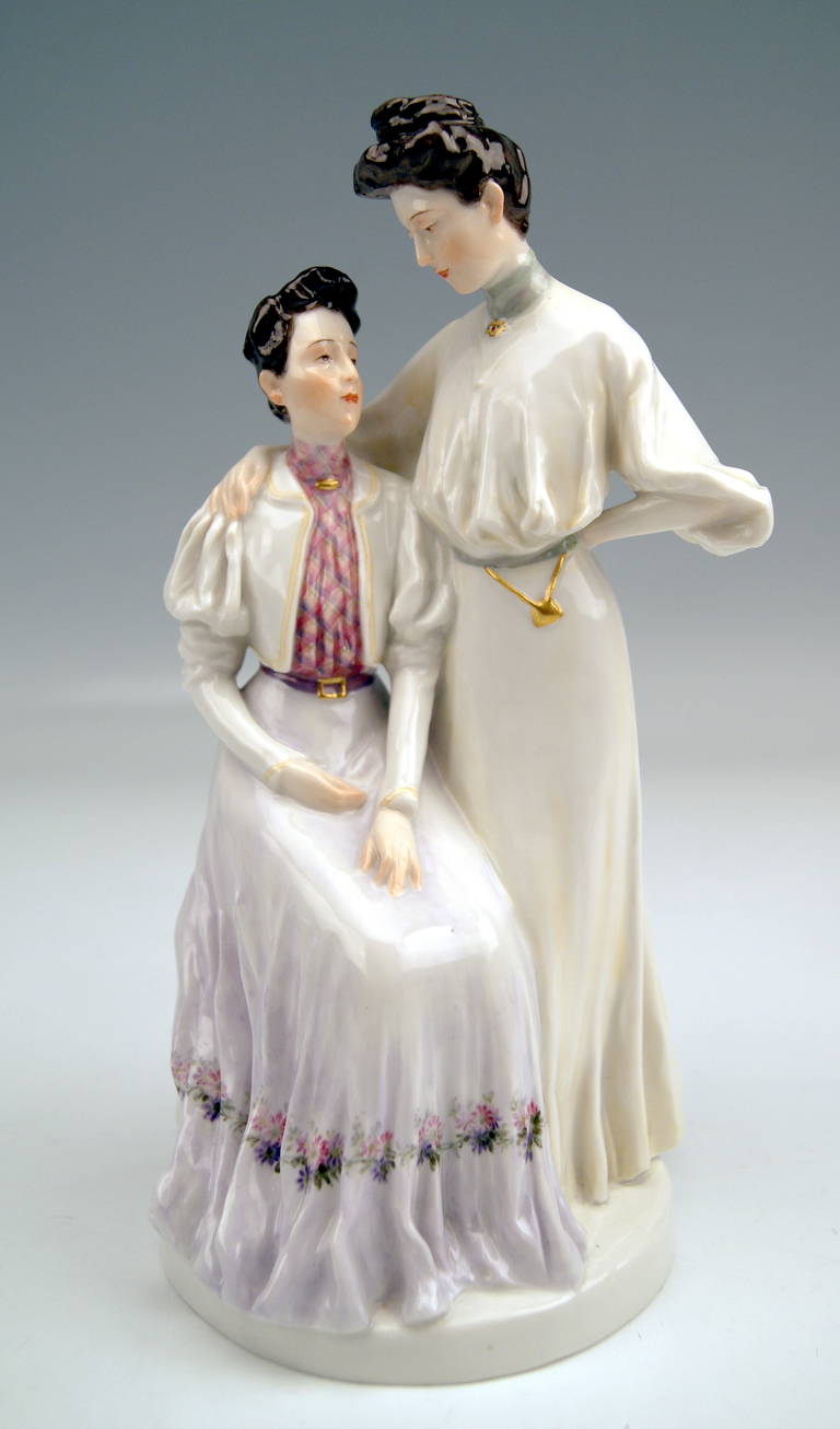 Meissen gorgeous as well as rarest figurine group created by Theodore Eichler (1868-1946)  in year 1907:  The Sisters.
There are two women visible. They are clad in fashion of Turn of Century (circa 1900). The woman who stands next to her sister