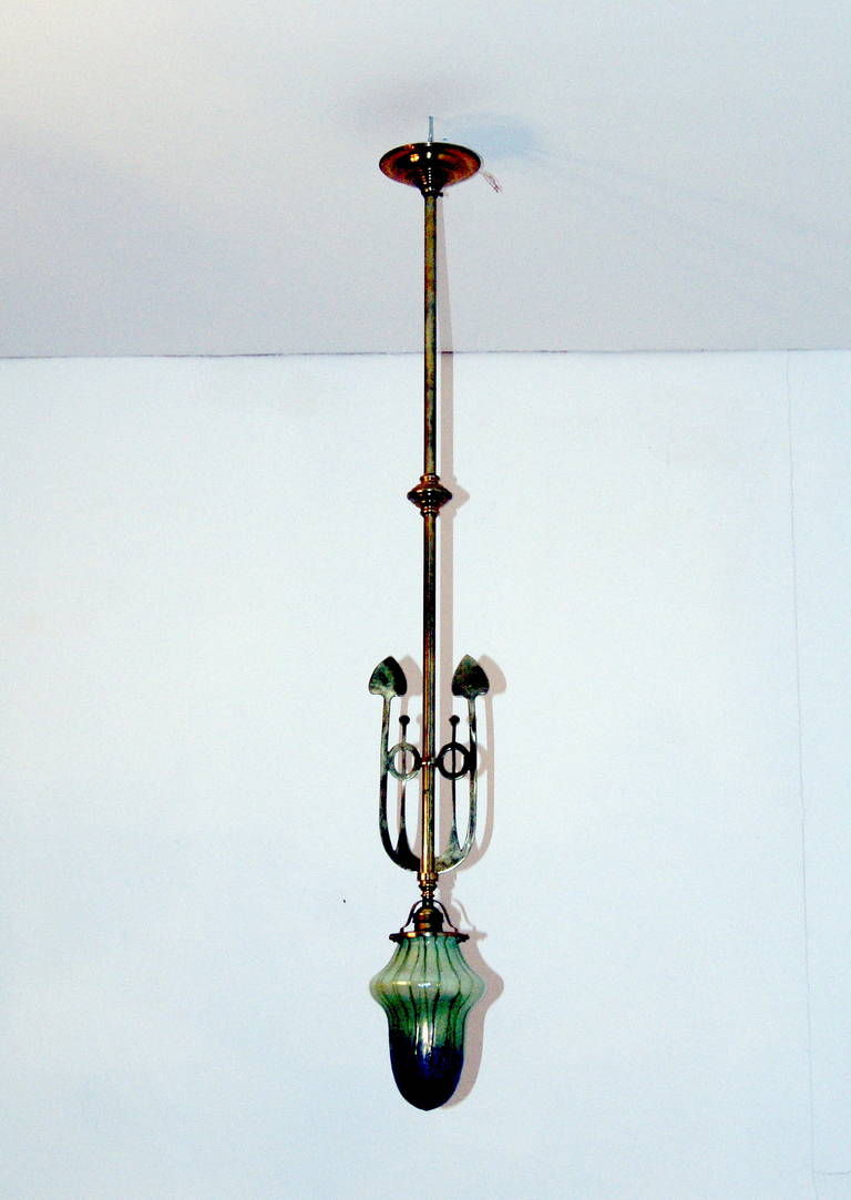 Excellent Art Nouveau suspended Viennese lamp (pendant) with Palme König Koenig glass shade,  made circa 1900.

milky glass of oblong  (capsule) form type with bulging running around, additionally, green vertical glass threads  melted on surface are