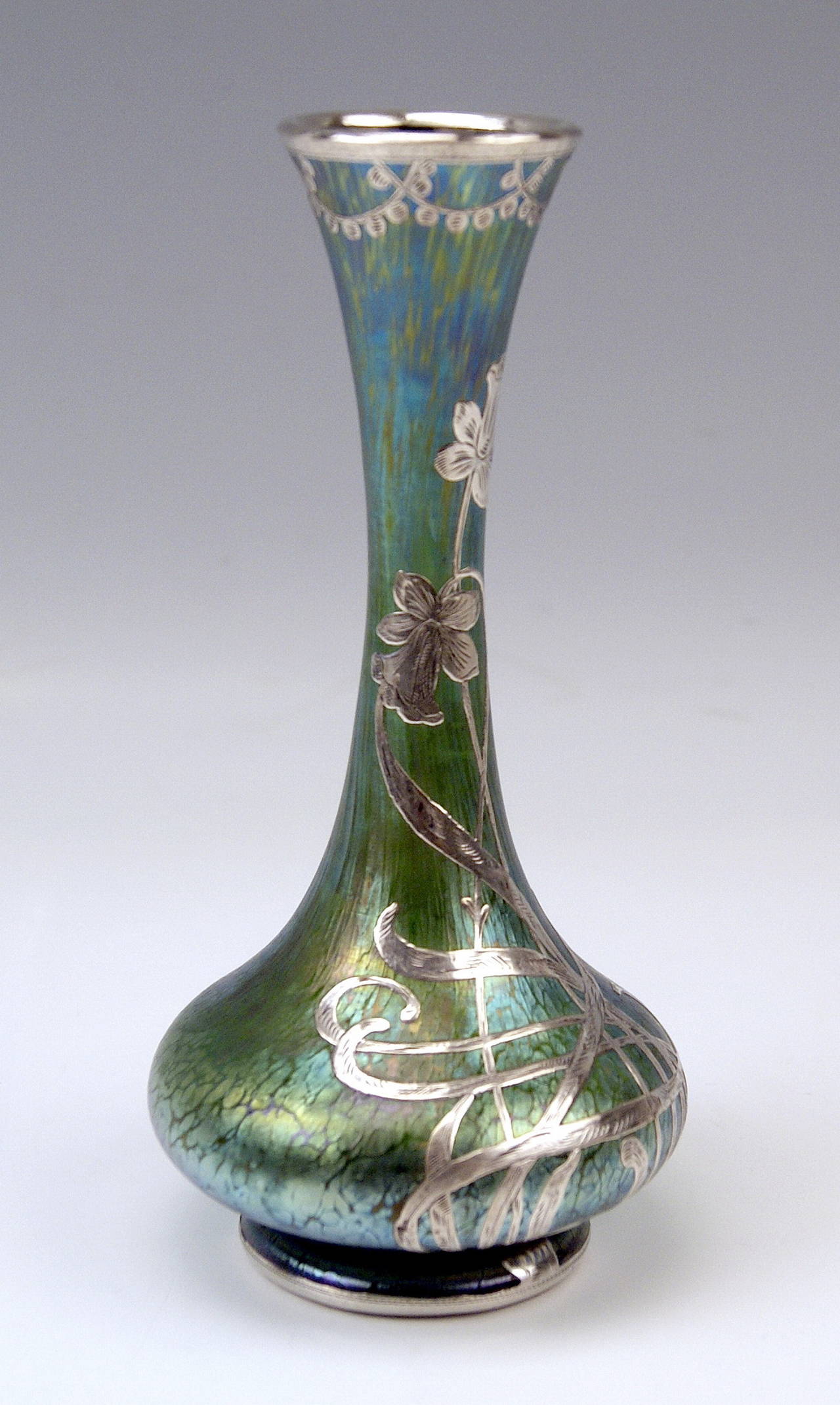 Vase Loetz Widow Klostermuehle Bohemia Art Nouveau.

Made by Loetz, Klostermuehle | circa 1900-1905.
Decor: Creta Papillon and stunning silver overlay.

This finest Loetz Art Nouveau Vase is of stalky as well as of tapering form type. The round