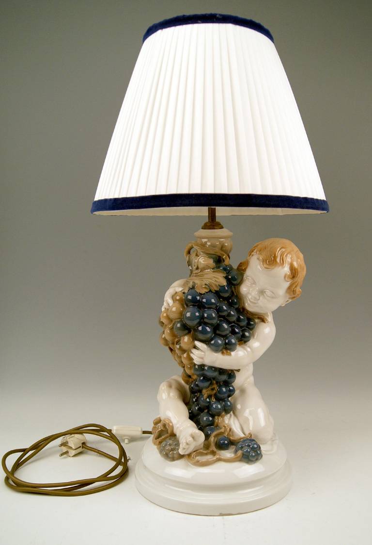 Gorgeous Rosenthal Germany Huge Cherub table lamp modeled by Constantin Holzer-Defanti/model created in year 1919 / manufactured during first quarter of the 20th century: made circa 1920-1925.

The huge lovely cherub's figurine embraces wine grapes