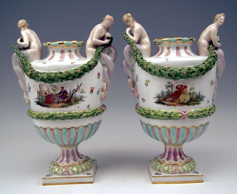 Meissen stunning rare pair of vases: Excellent as well as most remarkable modelling of Greek Amphora type, having handles shaped as sculptured female figurines of mermaids who hold garland of leaves in hands. The vases' outer walls are decorated