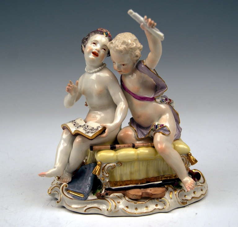 MEISSEN OUTSTANDING & LOVELY PAIR OF CHILDREN  (18TH CENTURY  1740-50):
Both figurines are undressed  /  they are situated on a cushioned stool on which a flute has been laid  /  the girl wearing a necklace holds a book with musical notes while