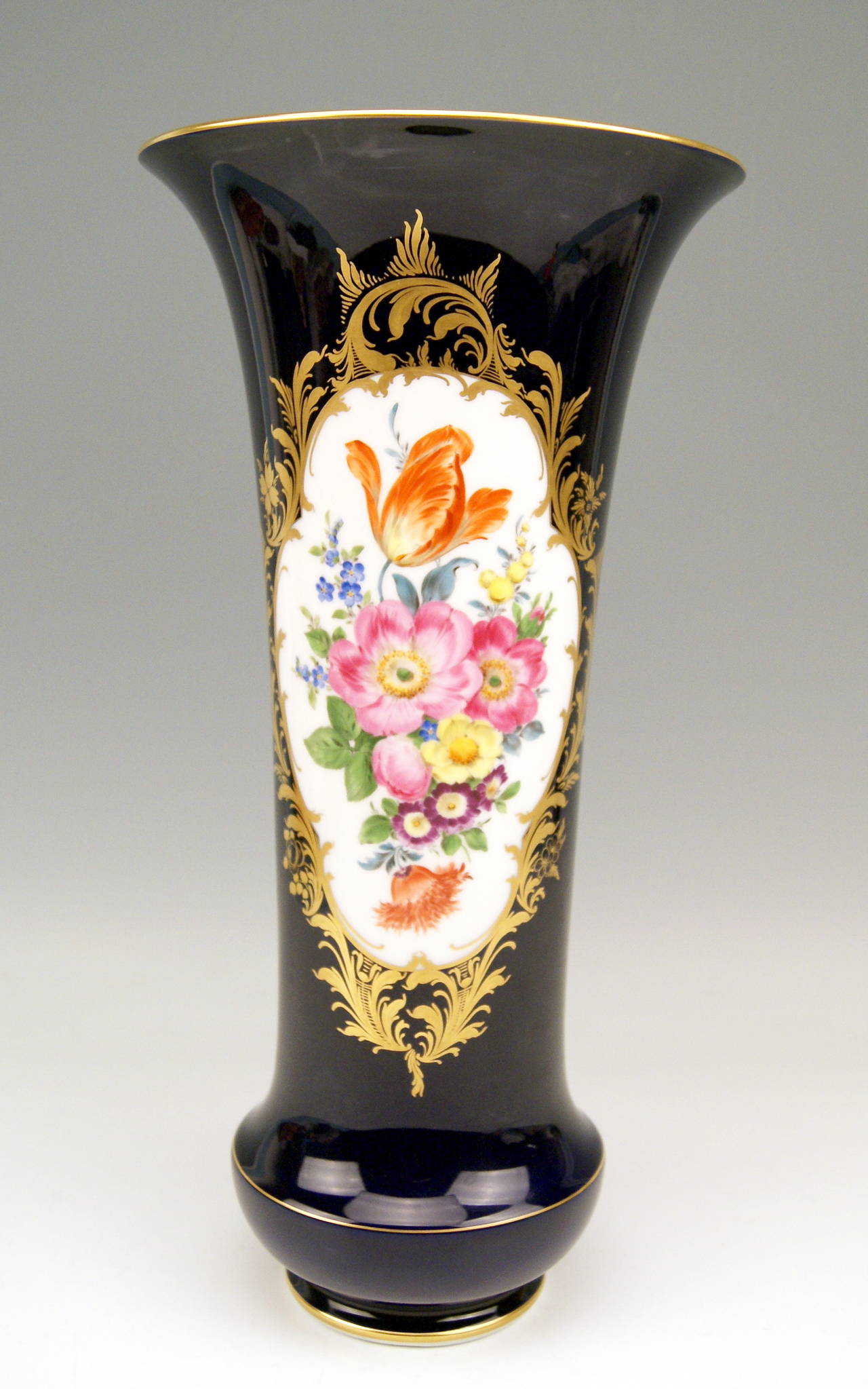 GORGEOUS TALL COBALT BLUE VASE OF FUNNELED FORM TYPE

MANUFACTORY:    MEISSEN
DATING:         made middle of 20th century   
MATERIAL:     WHITE PORCELAIN, GLOSSY FINISH, FINEST FLOWER PAINTING

This stunning  MEISSEN VASE of FUNNELED FORM