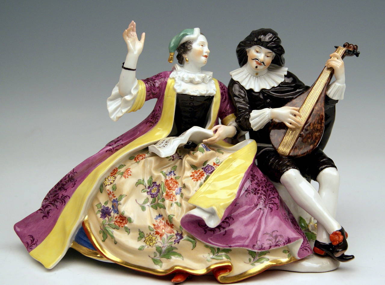 Meissen gorgeous as well as famous figurine group:  Scaramuz and Colombine Making Music.
DATING:            made during  PFEIFFER PERIOD  (1924 - 34)
MATERIAL:        white porcelain, glossy finish, finest painting 
TECHNIQUE:     handmade