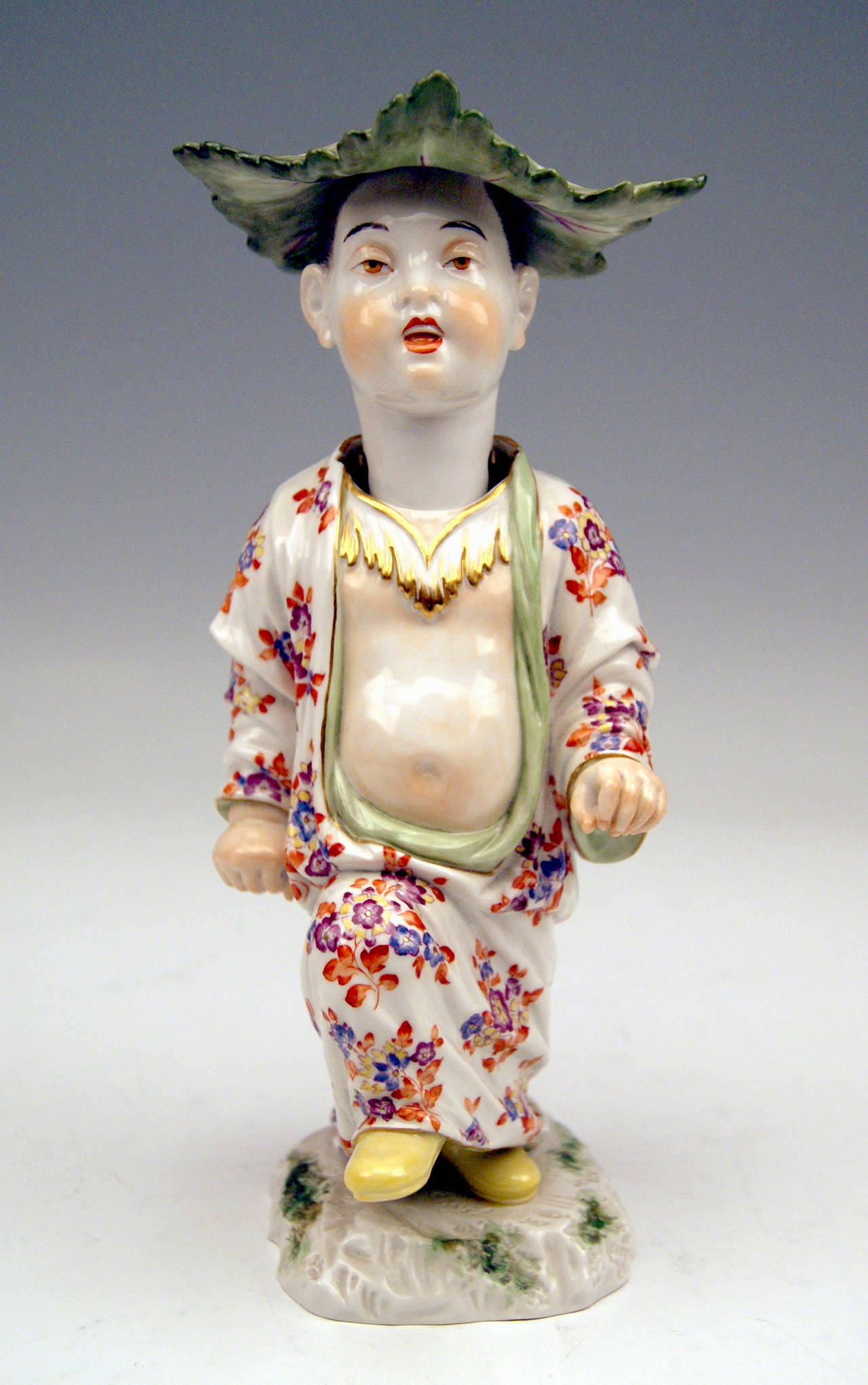 Meissen gorgeous as well as rarest figurine:  
Chinese Boy with Hat made of Cabbages' Leaves.
DATING:            made 20th century 
MATERIAL:        white porcelain, glossy finish, finest painting 
TECHNIQUE:     handmade
