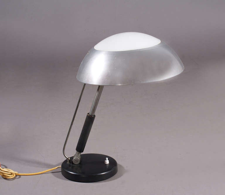 table light,
designer Karl Trabert,
prod. G.Schanzenbach und Co,
Germany, 1933.
table lamp with steel enemaled base and shade, painted wooden stam, metal shade with opal glass.
height 48cm, diameter 32cm.