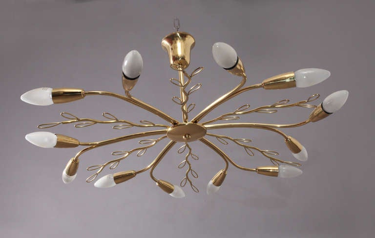 Rare original Sputnik by J.T.Kalmar Austria composed of branch-like split brass leaves with a gorgeous organically handcrafted appeal.
Twelve bulbs are illuminating this fixture which is in excellent vintage condition.
It ranges a bit between a