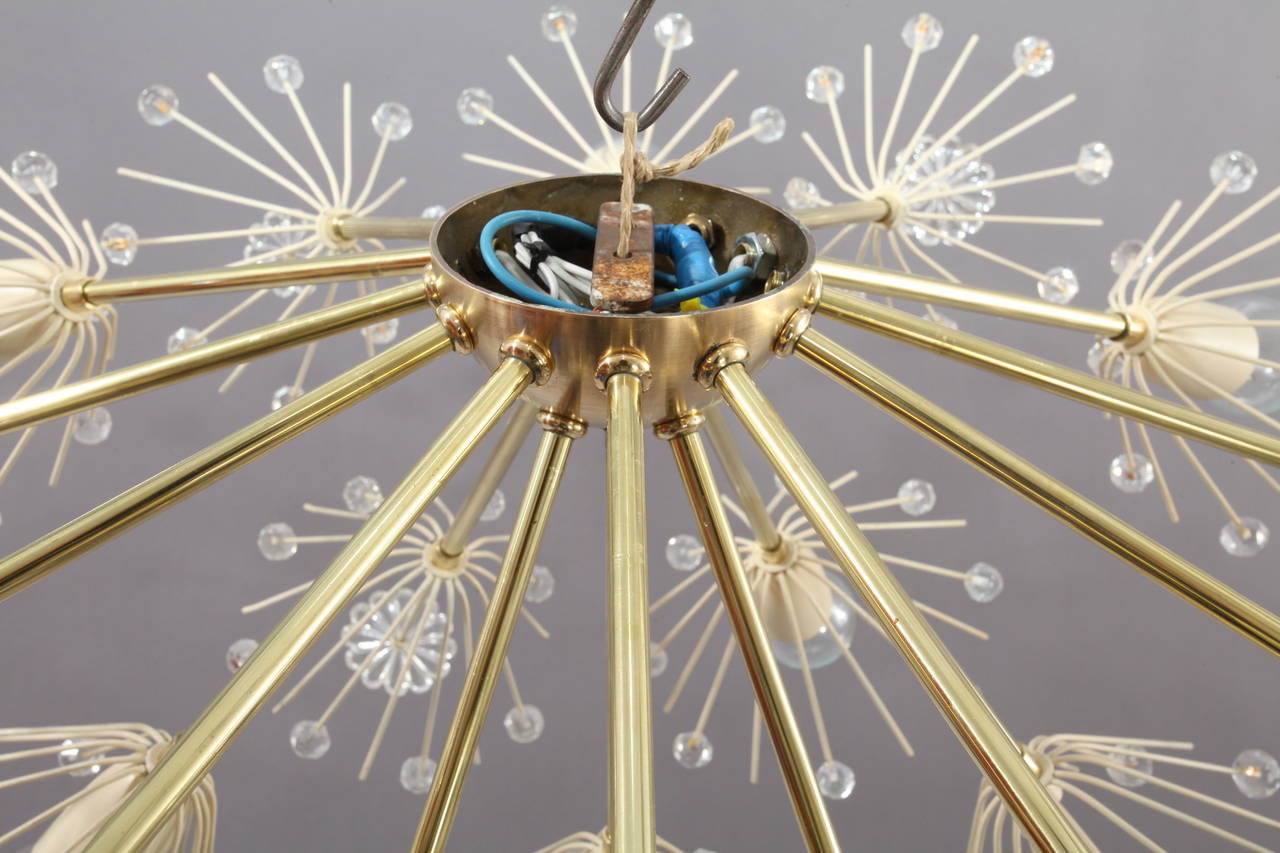 Fantastic large Emil Stejnar snowball flush mount ceiling light constructed of brass with cream colored painted florets and socket covers accented with crystal flowers and beads. Fifteen-light sockets use 25 watt max candelabra base bulbs.
Newly