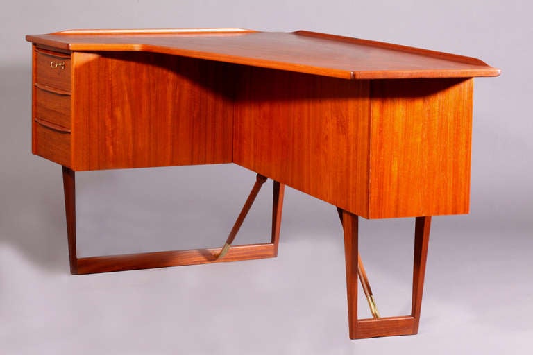 A very rare desk designed by Peter Lovig Nielsen for Hedensted Mobelfabrik, Denmark 1960.
Asymmetrical top with rolled edges, and brass and teak stretchers on the legs. Key opens both drawer and front storage. It has an open forward facing cabinet.