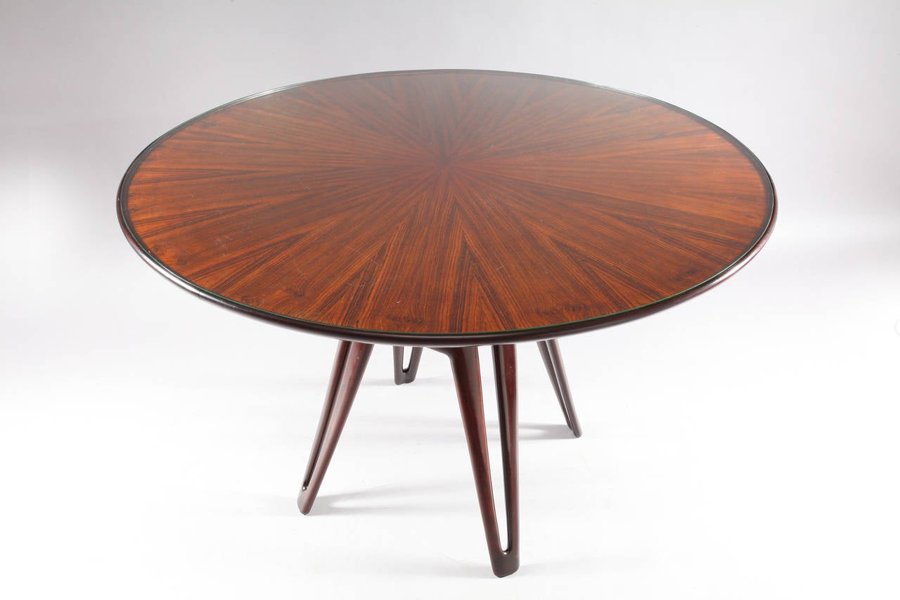 Round center or dining table,
designed by Vito Latis,
Italy, 1950.
Marquetry rosewood, glass plate.
Measures: Diameter 50 inch (126cm),
height 32inch (81cm).