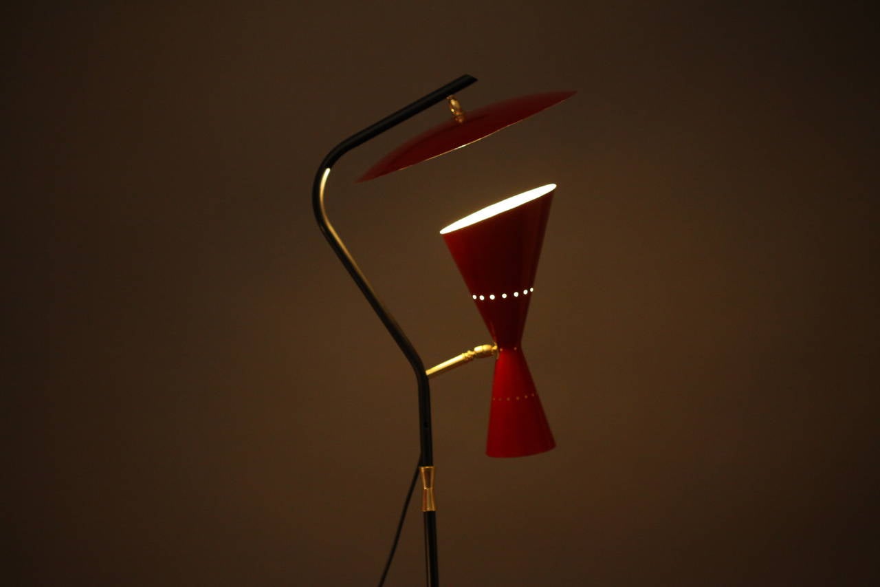 Floor lamp, Arredoluce, Italy, 1950. Black lacquered base and stem, dark red lacquered reflector and shade. Movable arm for reflection and spot function. Dimensions: Height 67inch (170cm).