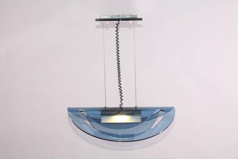 Hanging lamp,
Fontana Arte style,
Italy, 1980s.
Curved blue transparent glass.
Measures: Height 80