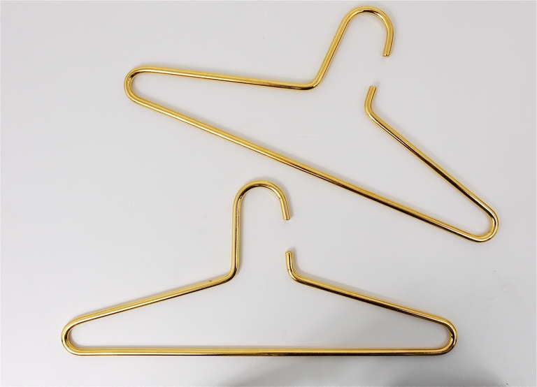 A pair of very beautiful hangers, designed an executed by Carl Aubock, Vienna, in the 1970s. Made of gold-plated brass, very stylish pieces in excellent condition. 16 1/2
