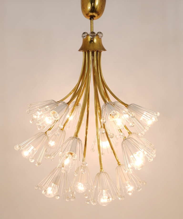 A beautiful and unusual floral brass chandelier in the shape of a bouquet of flowers. Designed by Emil Stejnar, executed in the 1950s by Rupert Nikoll Vienna. A decorative chandelier with white blossoms, covered with Austrian crystals. Has 14 arms,