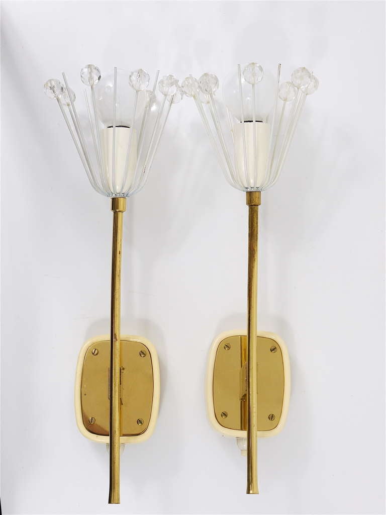A very beautiful pair of Viennese floral brass sconces, designed by Emil Stejnar, executed in the 1950s by Rupert Nikoll Vienna. Very decorative lights with white blossoms, covered with Austrian crystals, with integrated switches.  In very good