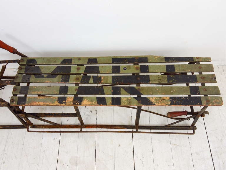 A very decorative 100-year-old military sleigh with steering wheel and brakes made of iron and wood. Unrestored, with signs of age, sold as displayed on the pictures. 61