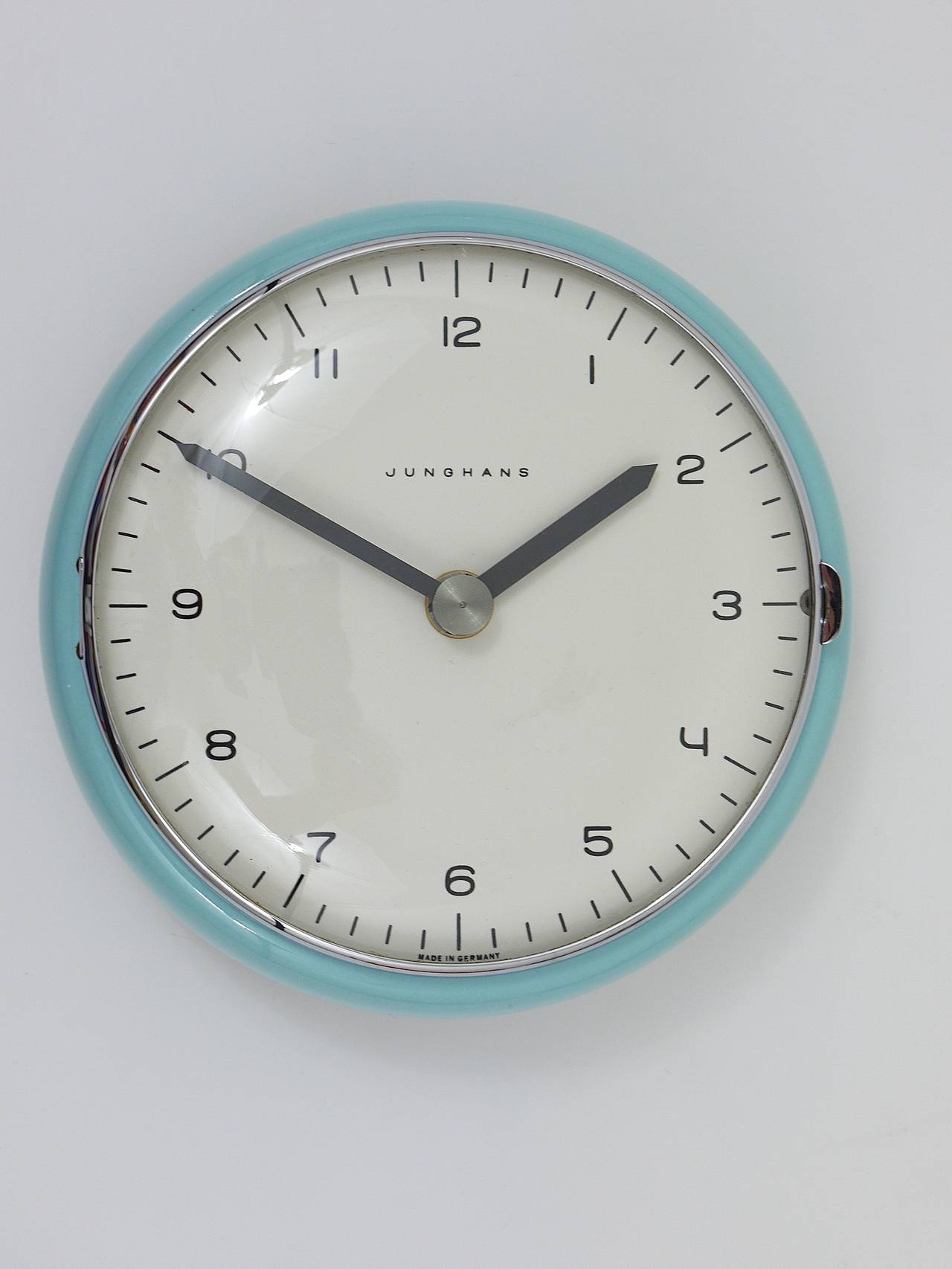 A rare, round mid-century wall clock, designed by Max Bill, executed by Junghans Germany in the 1950s. A beautiful wall clock, with light blue ceramic housing. Powered by its original battery-operated movement. In excellent condition.
