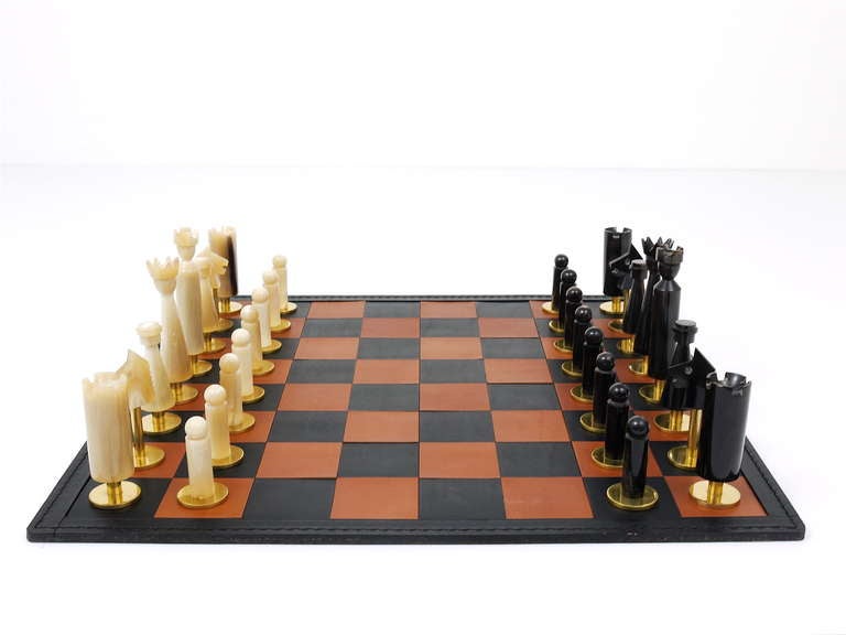 Very exceptional and beautiful chess game/chess men, plus leather chessboard, designed and executed in the late 1950s by Austrian Modernist Carl Aubock. Discontinued vintage chess game, made of light and dark cow horn and solid brass. In excellent