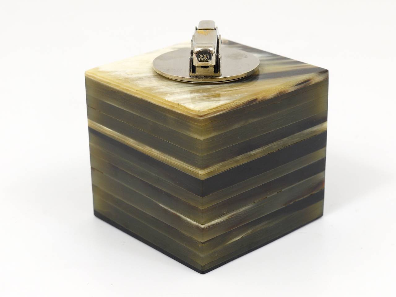 A beautiful table lighter, designed end executed in the 1950s by Carl Aubock, Vienna. A cube made of cow horn, with an integrated fuel lighter on top. Very good condition, nice patina, a very decorative object.