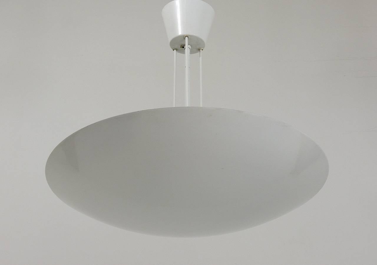  A white uplight pendant lamp, executed by Kalmar Vienna, 1970s. This straight-lined lamp is making a wonderful soft light. In very good condition with a few fine scratches on the center rod. The lamp takes 3 bulps up to 150W each.  