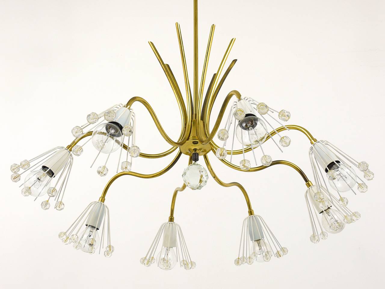 A beautiful Viennese mid century brass crystal chandelier. Designed by Emil Stejnar, executed by Rupert Nikoll in the 1950s. In very good condition with charming patina. 

Please notice, we offer to adjust the chandelier to the height you wish.