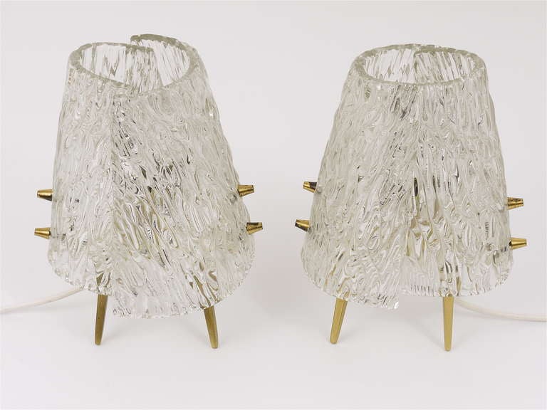 A pair of lovely brass and glass table / side / nightstand lamps from the 1950s, manufactured by J.T. Kalmar Vienna Austria. They have nice brass bases with four legs and brass knobs and the lampshade were made of two pieces of solid curved and
