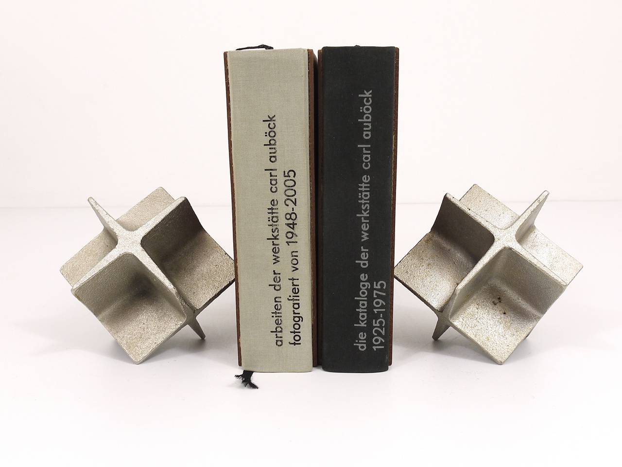 Beautiful pair of Austrian modernist bookends, designed and executed in the 1960s by Carl Aubock, Vienna. Very solid, made of nickel-plated cast-iron. In good condition with nice patina.