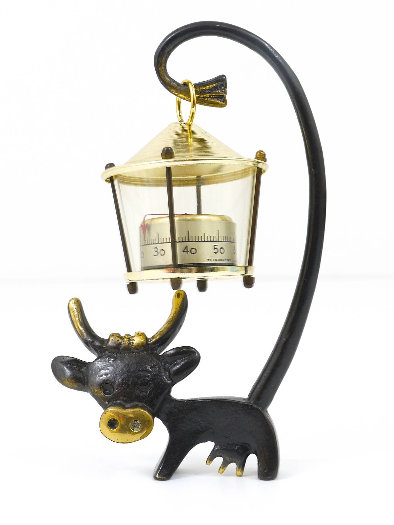 A charming sculptural Austrian midcentury desk thermometer, displaying a cow with a lantern-shaped thermometer. A humorous design by Walter Bosse, executed by Hertha Baller Austria in the 1950s. Made of brass, in excellent condition.