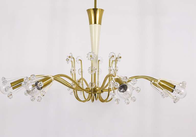 A beautiful, floral brass chandelier from the 1950s, designed by Emil Stejnar, executed by Rupert Nikoll Vienna. Has 10 arms and a lot of crystals and glass flower elements on it. In good condition with charming patina. Diameter 29
