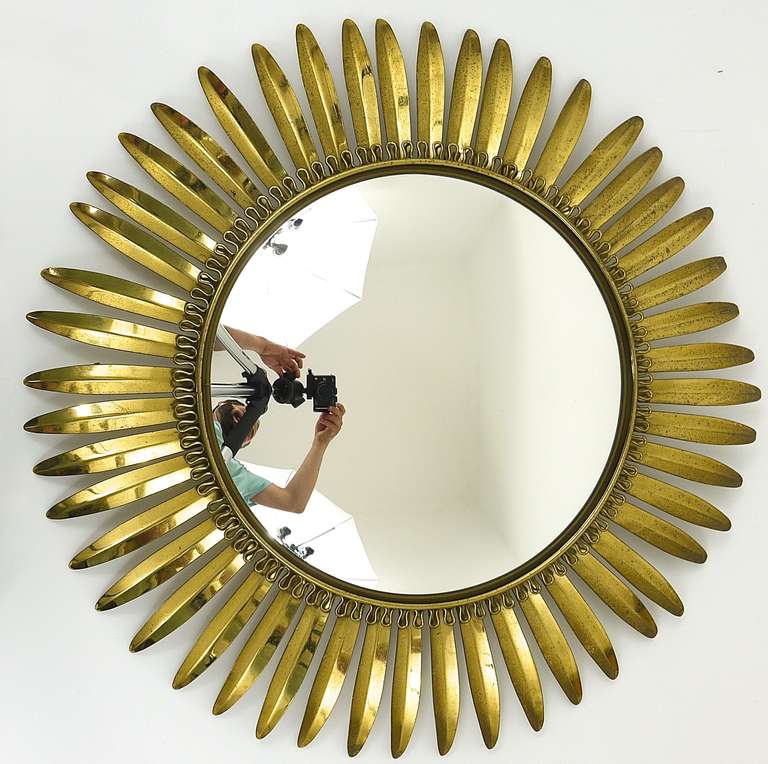 A beautiful convex wall mirror with a leaf brass frame. Made in France in the 1960s. In good condition, patina on the brass. Very decorative piece. Diameter 22