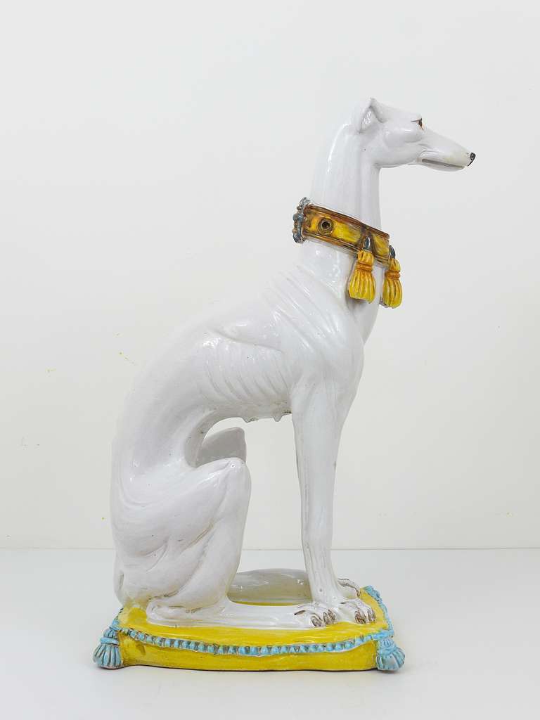 white ceramic greyhound statue