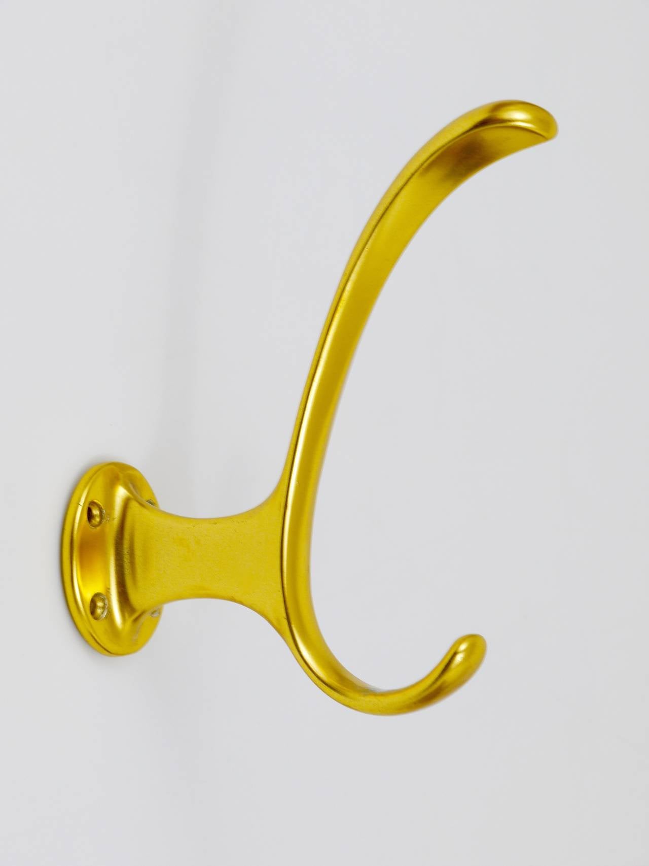 A set of 4 beautiful modernist wall hooks, executed in the 1950s in Austria. Made of gold-finished aluminium, in very good condition, with marginal patina.