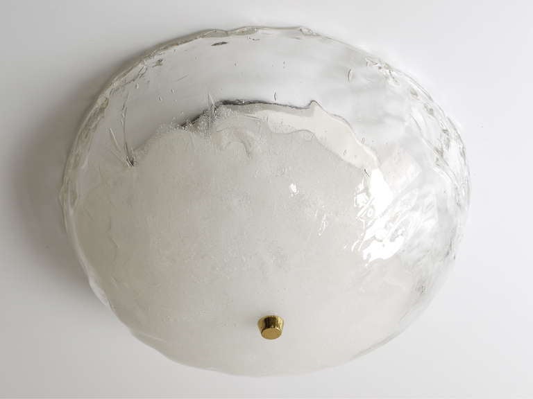 A beautiful vintage round flush mount or ceiling lamp, executed by J. T. Kalmar Vienna in the 1970s. Has a white painted metal base with three sockets and a big round bowl lampshade, made of solid, thick clear and white melting crystal glass.
