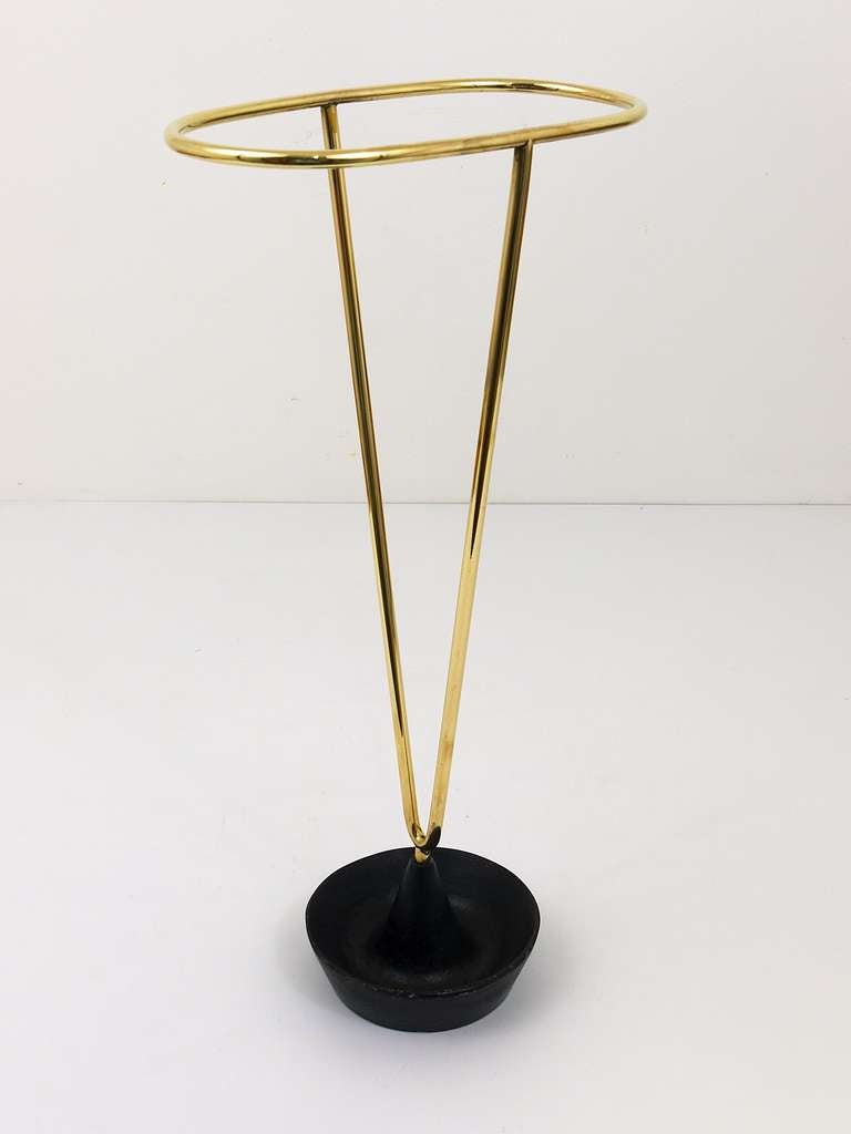 A very straight and beautiful Austrian umbrella stand, made of brass and cast iron. Designed and executed by Carl Aubock. A very sophisticated piece, one of the most beautiful umbrella stands we know. In good condition with nice patina on the base.