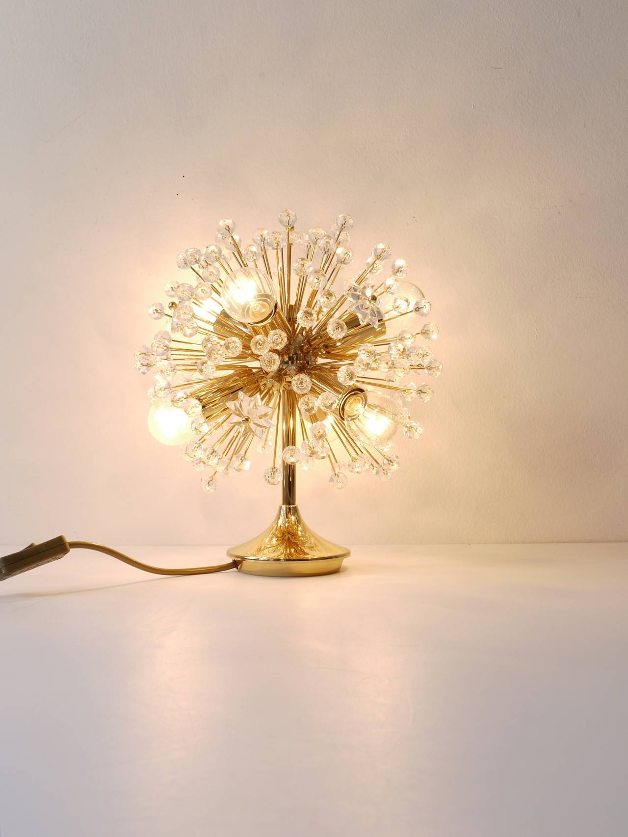 A beautiful Austrian snowflake blowball Sputnik table or side lamp. Gold-plated brass. Designed by Emil Stejnar, executed by the Austrian manufacturer Rupert Nikoll. Excellent condition, this lamp is unused.