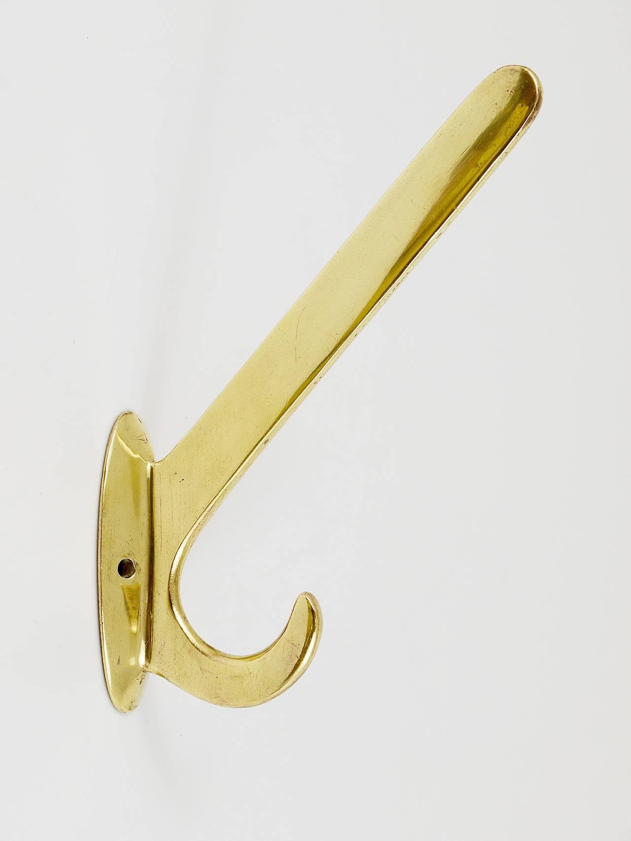 Up to four beautiful brass wall hooks, handmade in the 1920s, Vienna, Austria. Gently polished by hand, in excellent condition with marginal patina. Sold and priced per piece.