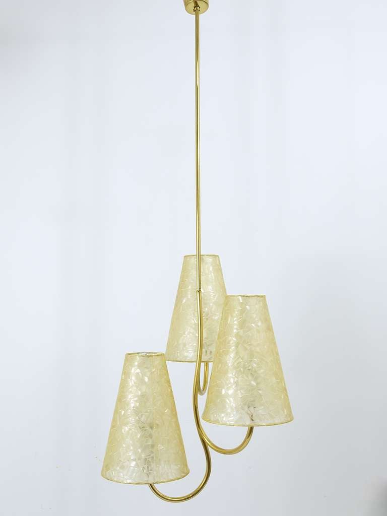 An elegante and charming Viennese modernist chandelier with three arms, designed by Josef Frank. In very good condition, which has still its original lampshades.