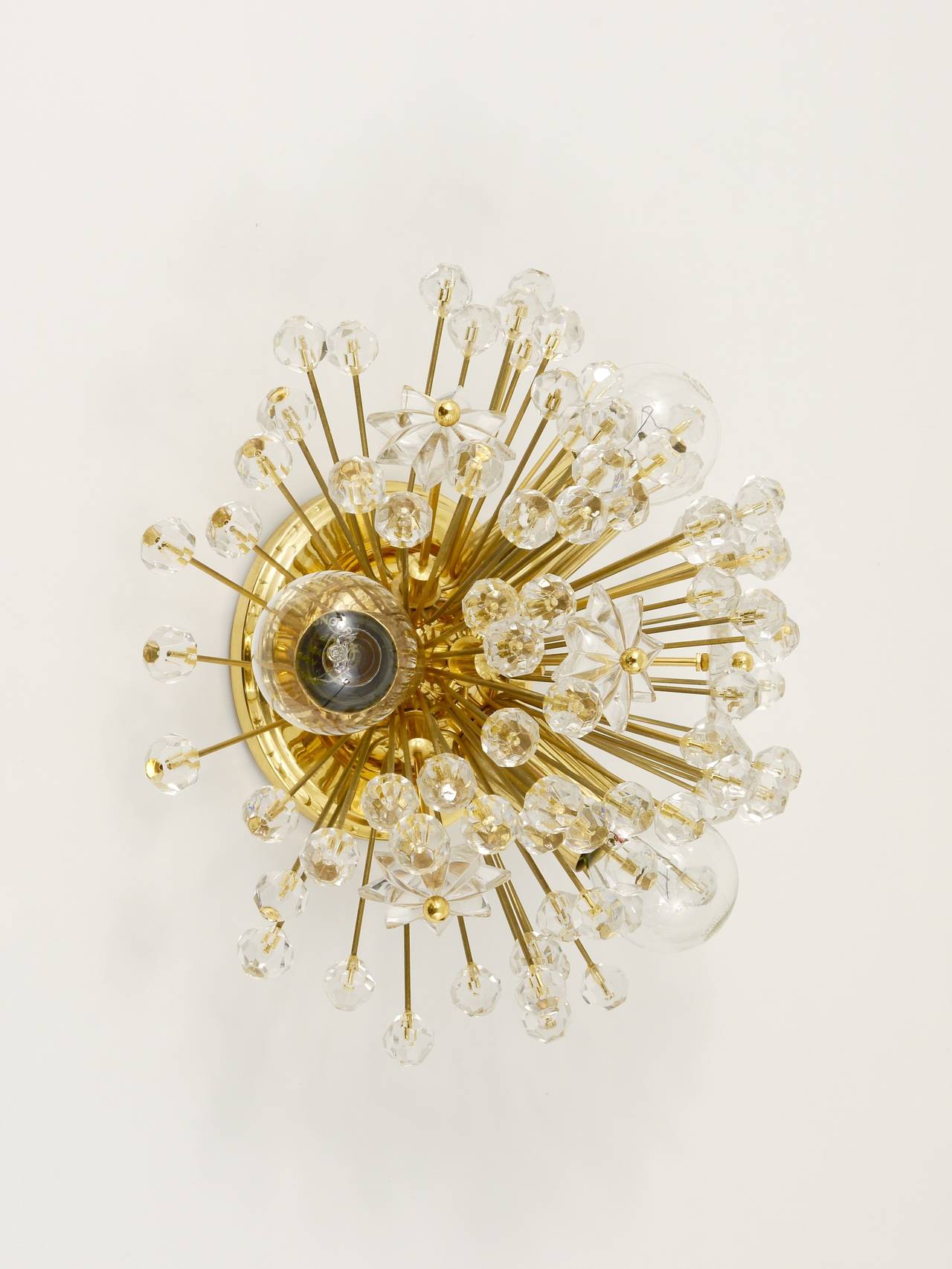 A beautiful Austrian blowball Sputnik lamp, to use as a wall lamp or flush mount. 24-karat gold-plated model. Designed by Emil Stejnar, executed by Rupert Nikoll in the 1970s. It has three sockets, the lamp is fully covered with Austrian crystal